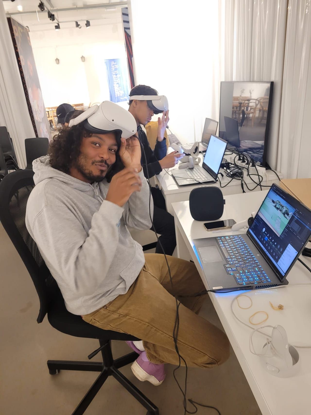 Young people working with VR headsets and laptops at Veldboom Studios